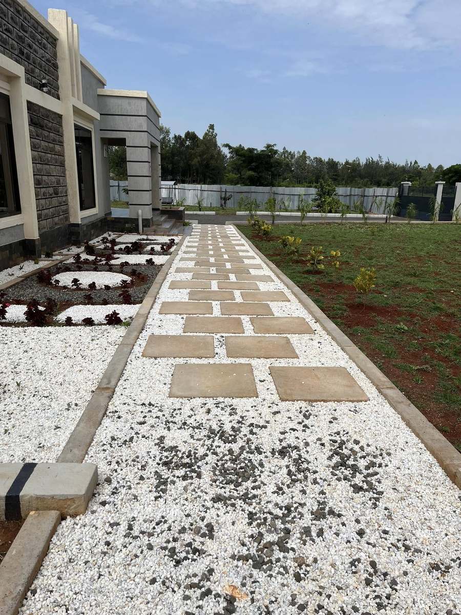 White pebble path with circular planting beds